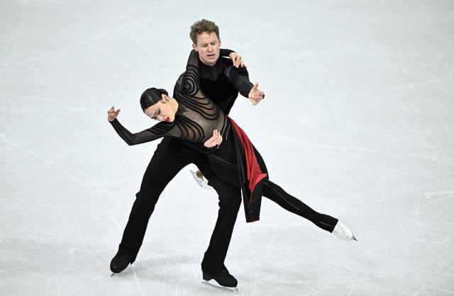 USA's Madison Chock (L) and USA's Evan Bates compete in the figure skating team event ice dance-free dance during the Milano Cortina 2026 Winter Olympic Games at Milano Ice Skating Arena in Milan on February 7, 2026. (Photo by JULIEN DE ROSA / AFP)