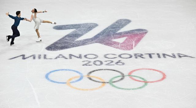 Italy's Marco Fabbri (L) and Italy's Charlene Guignard compete in the figure skating team event ice dance-free dance during the Milano Cortina 2026 Winter Olympic Games at Milano Ice Skating Arena in Milan on February 7, 2026. (Photo by JULIEN DE ROSA / AFP)