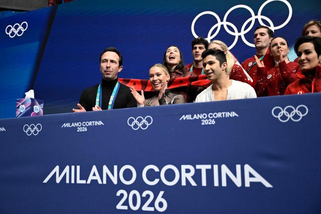 Canada's Marjorie Lajoie (bottom row, 2L) and Canada's Zachary Lagha (bottom row, 2R) react in the kiss and cry area after competing in the figure skating team event ice dance-free dance during the Milano Cortina 2026 Winter Olympic Games at Milano Ice Skating Arena in Milan on February 7, 2026. (Photo by WANG Zhao / AFP)