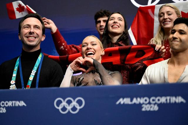 Canada's Marjorie Lajoie (C) and Canada's Zachary Lagha (R) react in the kiss and cry area after competing in the figure skating team event ice dance-free dance during the Milano Cortina 2026 Winter Olympic Games at Milano Ice Skating Arena in Milan on February 7, 2026. (Photo by WANG Zhao / AFP)