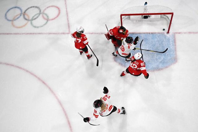 Canada's #88 Julia Gosling (bottom) and Canada's #19 Brianne Jenner celebrate scoring a goal during the women's preliminary round Group A Ice Hockey match between Switzerland and Canada at the Milano Rho Ice Hockey Arena at the Milano Cortina 2026 Winter Olympic Games in Milan, on February 7, 2026. (Photo by Alexander NEMENOV / AFP)