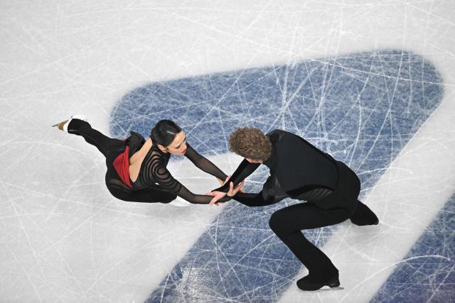 USA's Madison Chock (L) and USA's Evan Bates (R) compete in the figure skating team event ice dance-free dance during the Milano Cortina 2026 Winter Olympic Games at Milano Ice Skating Arena in Milan on February 7, 2026. (Photo by Antonin THUILLIER / AFP)