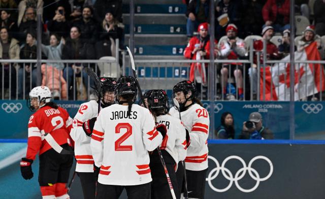 Canada's players celebrate scoring a goal during the women's preliminary round Group A Ice Hockey match between Switzerland and Canada at the Milano Rho Ice Hockey Arena at the Milano Cortina 2026 Winter Olympic Games in Milan, on February 7, 2026. (Photo by Alexander NEMENOV / AFP)
