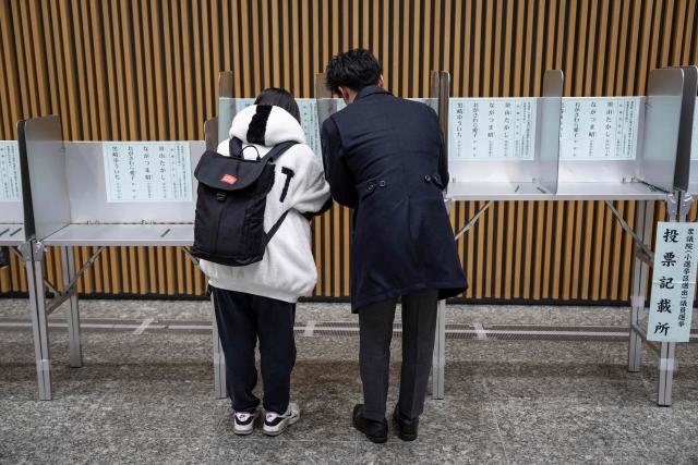 Voters take part in the House of Representatives election at a polling station in Tokyo on February 8, 2026. Japan voted in snap elections February 8 with Prime Minister Sanae Takaichi hoping to turn a honeymoon start into a resounding ballot box victory that could rile China and rattle financial markets. (Photo by Yuichi YAMAZAKI / AFP)