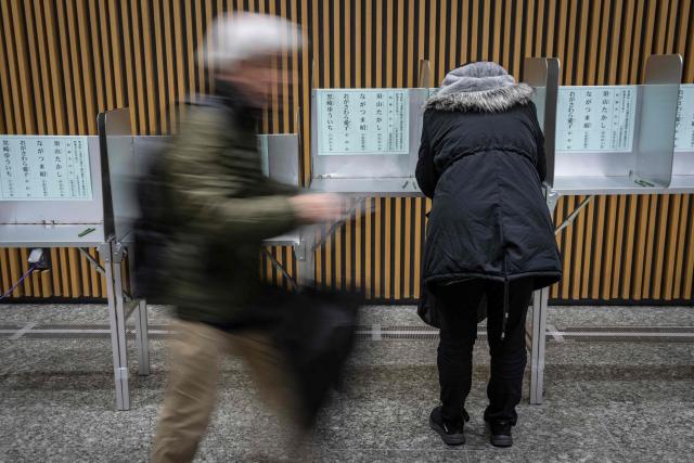 Voters take part in the House of Representatives election at a polling station in Tokyo on February 8, 2026. Japan voted in snap elections February 8 with Prime Minister Sanae Takaichi hoping to turn a honeymoon start into a resounding ballot box victory that could rile China and rattle financial markets. (Photo by Yuichi YAMAZAKI / AFP)