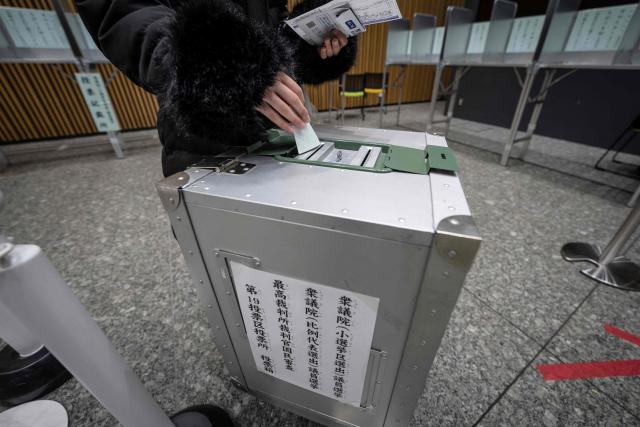 A voter casts their ballot in the House of Representatives election at a polling station in Tokyo on February 8, 2026. Japan voted in snap elections February 8 with Prime Minister Sanae Takaichi hoping to turn a honeymoon start into a resounding ballot box victory that could rile China and rattle financial markets. (Photo by Yuichi YAMAZAKI / AFP)