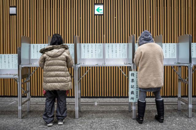 Voters take part in the House of Representatives election at a polling station in Tokyo on February 8, 2026. Japan voted in snap elections February 8 with Prime Minister Sanae Takaichi hoping to turn a honeymoon start into a resounding ballot box victory that could rile China and rattle financial markets. (Photo by Yuichi YAMAZAKI / AFP)