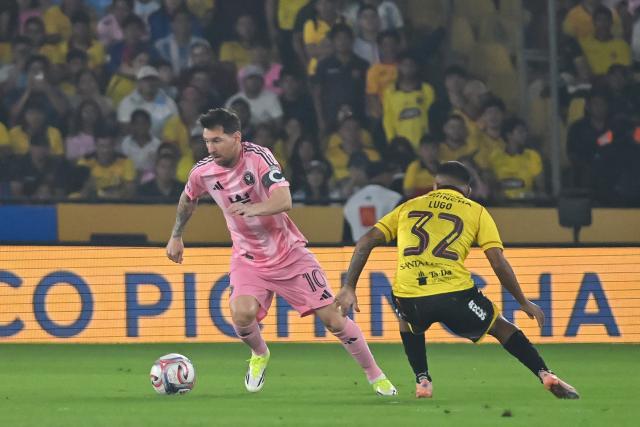 Inter Miami's Argentine forward #10 Lionel Messi runs with the ball past Barcelona's Argentine midfielder #32 Matias Lugo during the friendly football match between Ecuador's Barcelona and the US' Inter Miami at the Banco Pichincha Stadium in Guayaquil, Ecuador, on February 7, 2026. (Photo by Marcos PIN / AFP)