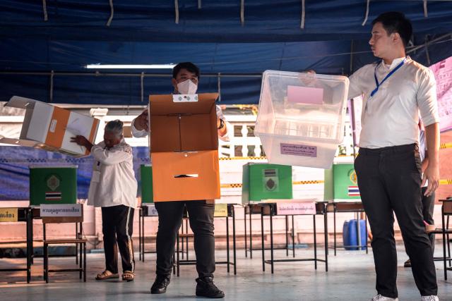 CORRECTION / Officials show that ballot boxes are empty before the start of voting in Thailand's general election in Bangkok on February 8, 2026. Voting opened on February 8 in a Thai general election pitting the popular reformists who came first last time against the conservative who ended up as prime minister, with ex-leader Thaksin Shinawatra looming large from his prison cell. (Photo by Chanakarn LAOSARAKHAM / AFP) / The erroneous mention[s] appearing in the metadata of this photo has been modified in AFP systems in the following manner: [correcting byline to Chanakarn Laosarakham] instead of [Lillian Suwanrumpha]. Please immediately remove the erroneous mention[s] from all your online services and delete it (them) from your servers. If you have been authorized by AFP to distribute it (them) to third parties, please ensure that the same actions are carried out by them. Failure to promptly comply with these instructions will entail liability on your part for any continued or post notification usage. Therefore we thank you very much for all your attention and prompt action. We are sorry for the inconvenience this notification may cause and remain at your disposal for any further information you may require.