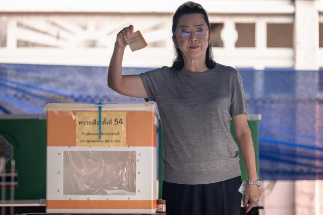 CORRECTION / Yaowapha Wongsawat, mother of Pheu Thai Party's prime ministerial candidate Yodchanan Wongsawat, holds her ballot as she votes in Thailand's general election at a polling station in Bangkok on February 8, 2026. (Photo by Chanakarn LAOSARAKHAM / AFP) / “The erroneous mention[s] appearing in the metadata of this photo has been modified in AFP systems in the following manner: [byline is Chanakarn Laosarakham] instead of [Lillian Suwanrumpha]. Please immediately remove the erroneous mention[s] from all your online services and delete it (them) from your servers. If you have been authorized by AFP to distribute it (them) to third parties, please ensure that the same actions are carried out by them. Failure to promptly comply with these instructions will entail liability on your part for any continued or post notification usage. Therefore we thank you very much for all your attention and prompt action. We are sorry for the inconvenience this notification may cause and remain at your disposal for any further information you may require.”