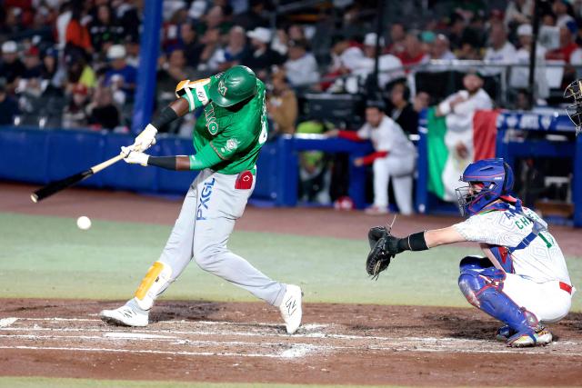 Tomateros de Culiacan's #47 Estevan Florial (L) bats past Charros de Jalisco's #15 Jose Chavez (R) in the third inning of the Caribbean Series baseball tournament final game between Mexico's Tomateros de Culiacán and Charros de Jalisco at the Panamerican Stadium in Jalisco, Mexico, on February 7, 2026. (Photo by Ulises Ruiz / AFP)