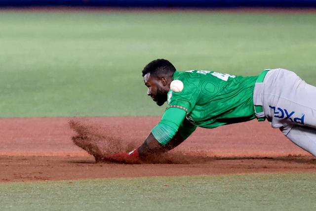 Tomateros de Culiacan's #47 Estevan Florial slides between bases in the third inning of the Caribbean Series baseball tournament final game between Mexico's Tomateros de Culiacán and Charros de Jalisco at the Panamerican Stadium in Jalisco, Mexico, on February 7, 2026. (Photo by Ulises RUIZ / AFP)