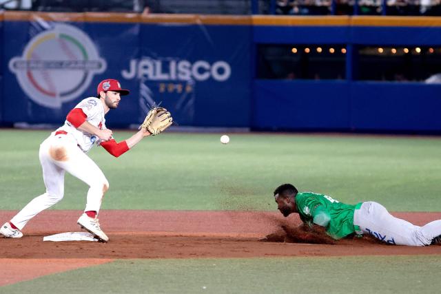 Tomateros de Culiacan's #47 Estevan Florial (R) slides to third base in front of Charros de Jalisco's #26 Michael Wielansky (L) in the third inning of the Caribbean Series baseball tournament final game between Mexico's Tomateros de Culiacán and Charros de Jalisco at the Panamerican Stadium in Jalisco, Mexico, on February 7, 2026. (Photo by Ulises RUIZ / AFP)