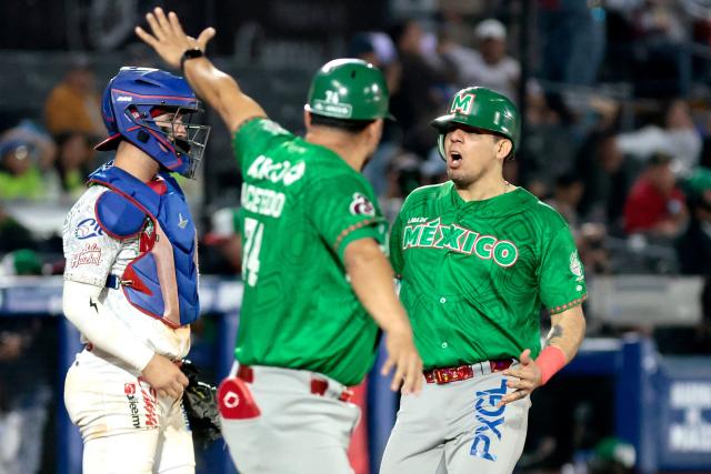 Tomateros de Culiacan's #25 Victor Mendoza (R) celebrates in the fifth inning of the Caribbean Series baseball tournament final game between Mexico's Tomateros de Culiacán and Charros de Jalisco at the Panamerican Stadium in Jalisco, Mexico, on February 7, 2026. (Photo by Ulises RUIZ / AFP)