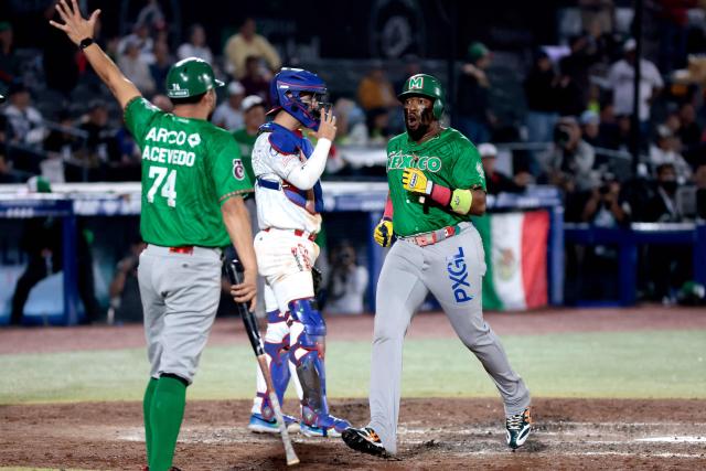 Tomateros de Culiacan's #33 Yadir Drake (R) celebrates in the fifth inning of the Caribbean Series baseball tournament final game between Mexico's Tomateros de Culiacán and Charros de Jalisco at the Panamerican Stadium in Jalisco, Mexico, on February 7, 2026. (Photo by Ulises RUIZ / AFP)