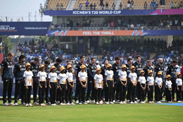 New Zealand players stand for the national anthem before the start of the 2026 ICC Men's T20 Cricket World Cup group stage match between Afghanistan and New Zealand at the MA Chidambaram Stadium in Chennai on February 8, 2026. (Photo by R. Satish BABU / AFP)