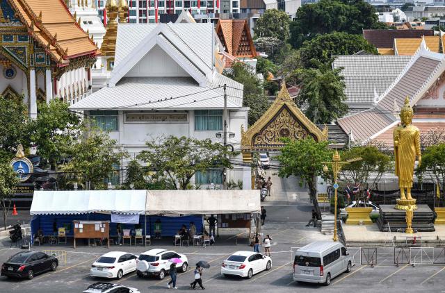 Voters arrive to cast their ballots in Thailand's general election at a polling station outside a Buddhist temple in Bangkok on February 8, 2026. Thais voted on February 8 in an election pitting the popular reformists who came first last time against the conservative who ended up as prime minister, with ex-leader Thaksin Shinawatra looming large from his prison cell. (Photo by Amaury PAUL / AFP)