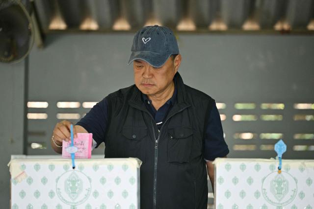 Thailand's Prime Minister and Bhumjaithai Party leader Anutin Charnvirakul casts his ballot in Thailand's general election at a polling station in Buriram province on February 8, 2026. Thais voted on February 8 in an election pitting the popular reformists who came first last time against the conservative who ended up as prime minister, with ex-leader Thaksin Shinawatra looming large from his prison cell. (Photo by ANTHONY WALLACE / AFP)