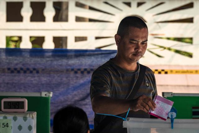 A man casts his ballot in Thailand's general election at a polling station in Bangkok on February 8, 2026. Voting opened on February 8 in a Thai general election pitting the popular reformists who came first last time against the conservative who ended up as prime minister, with ex-leader Thaksin Shinawatra looming large from his prison cell. (Photo by chanakarn laosarakham / AFP)