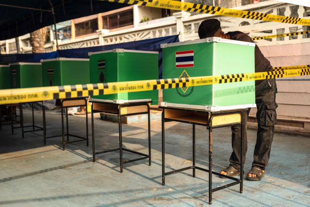 A man casts his ballot in Thailand's general election at a polling station in Bangkok on February 8, 2026. Voting opened on February 8 in a Thai general election pitting the popular reformists who came first last time against the conservative who ended up as prime minister, with ex-leader Thaksin Shinawatra looming large from his prison cell. (Photo by chanakarn laosarakham / AFP)