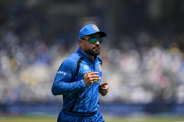 Afghanistan's captain Rashid Khan runs across the pitch during the 2026 ICC Men's T20 Cricket World Cup group stage match between Afghanistan and New Zealand at the MA Chidambaram Stadium in Chennai on February 8, 2026. (Photo by R. Satish BABU / AFP)