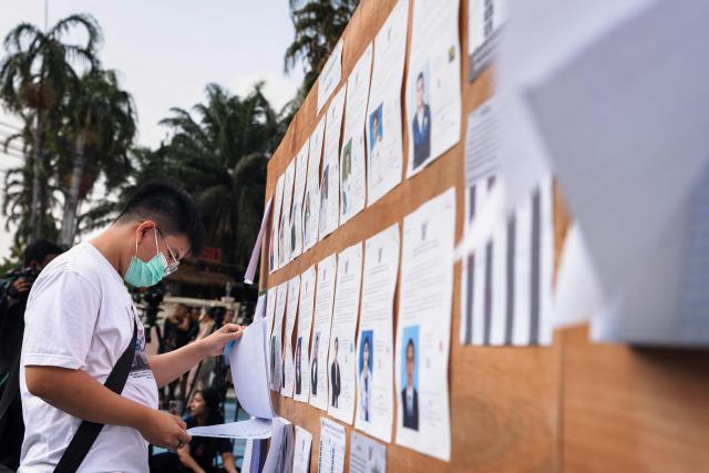 A man looks for his name in the voter registration list for Thailand's general election in Bangkok on February 8, 2026. Thais voted on February 8 in an election where progressive reformists were the runaway opinion poll leaders but the incumbent conservative prime minister is expected to end up retaining his position, extending the country's political stand-off. (Photo by Chanakarn LAOSARAKHAM / AFP)