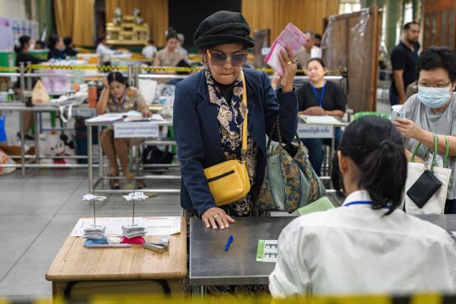 A voter registers to vote and cast her ballot in Thailand's general election in Bangkok on February 8, 2026. Thais voted on February 8 in an election where progressive reformists were the runaway opinion poll leaders but the incumbent conservative prime minister is expected to end up retaining his position, extending the country's political stand-off. (Photo by Chanakarn LAOSARAKHAM / AFP)
