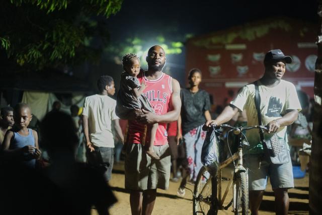Samuel Mavaieie, 35, poses for a portrait with his daughter at a school serving as a camp for internally displaced persons on February 7, 2026 in Xai-Xai, Gaza province, Mozambique. The latest flooding is among the worst Mozambique has seen in years, with officials warning the death toll could rise as more heavy rains loom and a nationwide red?alert remains in force. Across the region, floods have ripped through critical infrastructure -- roads, bridges, power lines and water systems. They have slowed aid deliveries and isolated entire communities. 
The N1 highway linking Maputo to the north remains cut. About 325,000 head of livestock have died and 285,000 hectares (704,250 acres) of farmland have been damaged, according to OCHA. (Photo by Zinyange Auntony / AFP)
