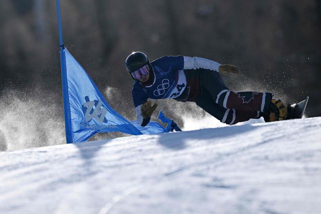 Canada's Arnaud Gaudet competes in the snowboard men's parallel giant slalom qualification run at Livigno Snow Park during the Milano Cortina 2026 Winter Olympic Games, in Livigno (Valtellina), on February 8, 2026. (Photo by Kirill KUDRYAVTSEV / AFP)