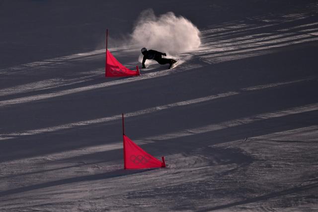 China's Bai Xinhui competes in the snowboard women's parallel giant Slalom elimination run at Livigno Snow Park during the Milano Cortina 2026 Winter Olympic Games, in Livigno (Valtellina), on February 8, 2026. (Photo by Jeff PACHOUD / AFP)