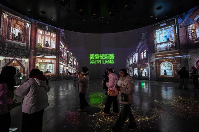 People visit iQIYI LAND, a new entertainment theme park developed by China's online entertainment platform iQIYI, on its opening day in Yangzhou, in eastern China's Jiangsu province on February 8, 2026. (Photo by Jade GAO / AFP)