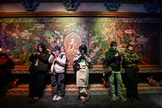 People visit iQIYI LAND, a new entertainment theme park developed by China's online entertainment platform iQIYI, on its opening day in Yangzhou, in eastern China's Jiangsu province on February 8, 2026. (Photo by Jade GAO / AFP)