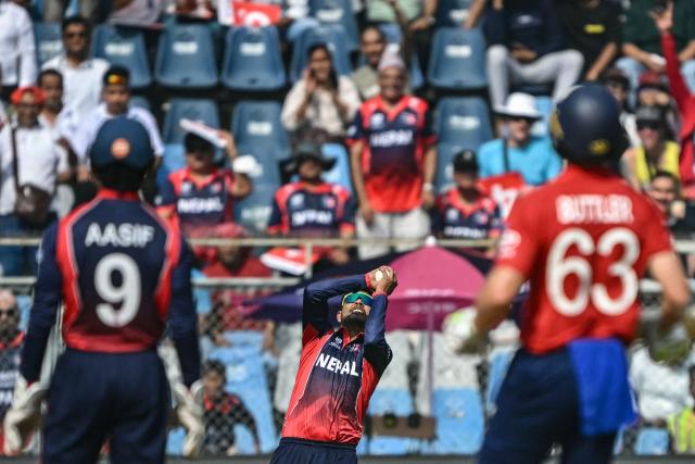Nepal's Sandeep Lamichhane (C) takes a catch to dismiss England's Phil Salt during the 2026 ICC Men's T20 Cricket World Cup group stage match between England and Nepal at the Wankhede Stadium in Mumbai on February 8, 2026. (Photo by Indranil MUKHERJEE / AFP)