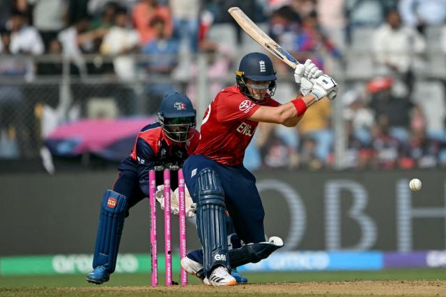 England's Jacob Bethell (R) plays a shot during the 2026 ICC Men's T20 Cricket World Cup group stage match between England and Nepal at the Wankhede Stadium in Mumbai on February 8, 2026. (Photo by Indranil MUKHERJEE / AFP)