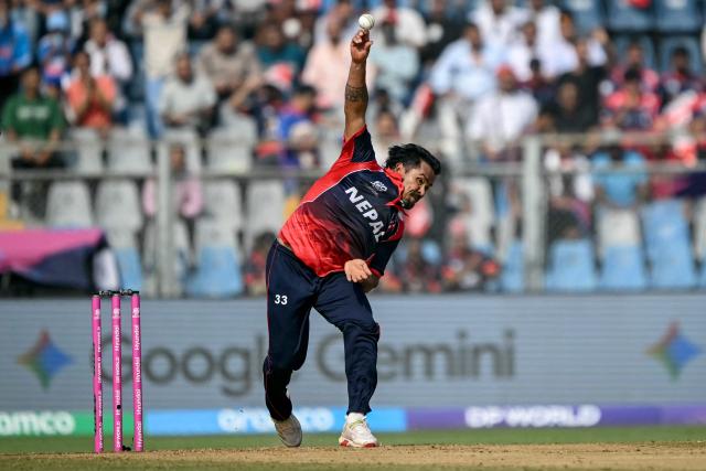 Nepal's Karan KC delivers a ball during the 2026 ICC Men's T20 Cricket World Cup group stage match between England and Nepal at the Wankhede Stadium in Mumbai on February 8, 2026. (Photo by Indranil MUKHERJEE / AFP)