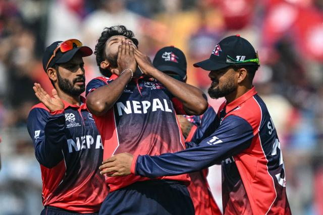 Nepal's Nandan Yadav (C) celebrates with teammates after taking the wicket of England's Jos Buttler during the 2026 ICC Men's T20 Cricket World Cup group stage match between England and Nepal at the Wankhede Stadium in Mumbai on February 8, 2026. (Photo by Indranil MUKHERJEE / AFP)