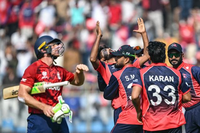 Nepal's Nandan Yadav (C) celebrates with teammates after taking the wicket of England's Jos Buttler (L) during the 2026 ICC Men's T20 Cricket World Cup group stage match between England and Nepal at the Wankhede Stadium in Mumbai on February 8, 2026. (Photo by Indranil MUKHERJEE / AFP)
