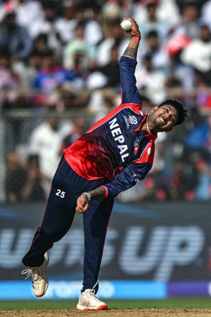 Nepal's Sandeep Lamichhane delivers a ball during the 2026 ICC Men's T20 Cricket World Cup group stage match between England and Nepal at the Wankhede Stadium in Mumbai on February 8, 2026. (Photo by Indranil MUKHERJEE / AFP)