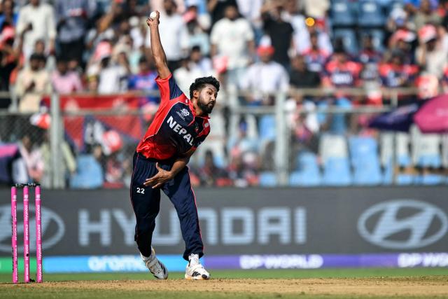 Nepal's Nandan Yadav delivers a ball during the 2026 ICC Men's T20 Cricket World Cup group stage match between England and Nepal at the Wankhede Stadium in Mumbai on February 8, 2026. (Photo by Indranil MUKHERJEE / AFP)