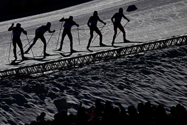 Athletes compete during the men's cross country 10km + 10km skiathlon event of the Milano Cortina 2026 Winter Olympic Games at Tesero Cross-Country Skiing Stadium in Lago di Tesero (Val di Fiemme), on February 8, 2026. (Photo by Tobias SCHWARZ / AFP)