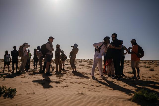 Blue March participants take a short break on their way to the village of Teichott at the Banc d’Arguin on February 6, 2026. The Blue March held its second edition this year at the Banc d’Arguin, a UNESCO World Heritage site marking its 50th anniversary. The citizen-led artistic and environmental initiative is organised by the Mauritanian Environmental Association (AME), and was initiated by Mauritanian-born Malian film director Abderrahmane Sissako and Senegalese screenwriter Kessen Fatoumata Tall.
The week-long collective walk aims to raise awareness of Mauritania’s biodiversity and foster dialogue on climate change and desertification among researchers, artists and policymakers. (Photo by Kang-Chun Cheng / AFP)