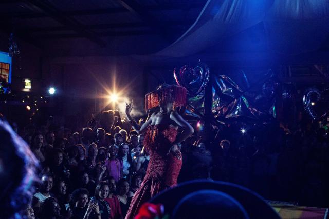 A participant walks the runway during competitions at the Love Pride Ball in Cape Town on February 7, 2026. Ballroom culture emerged in New York City in the late 1960s and 1970s, created by Black and Latino transgender and queer communities who were excluded from mainstream drag pageants. In response, they formed alternative kinship structures known as “Houses,” led by “Mothers” and “Fathers,” and organised “Balls,” competitive events where participants perform, walk categories and seek recognition within the community. (Photo by GIANLUIGI GUERCIA / AFP)