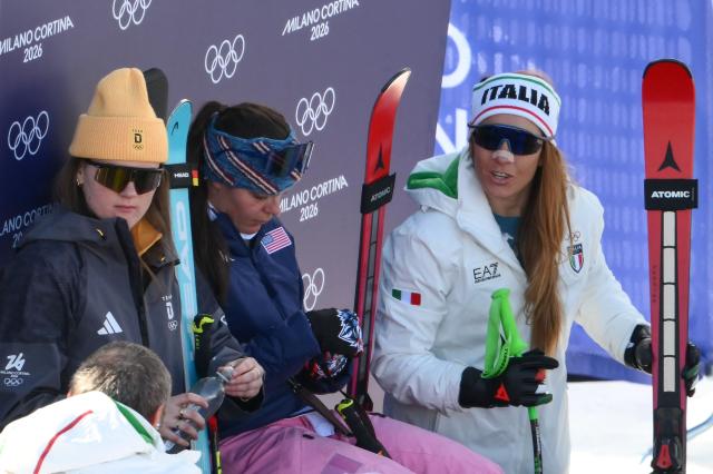 (From L) Germany's Emma Aicher, US' Breezy Johnson and Italy's Sofia Goggiaon reacts during the women's downhill event during the Milano Cortina 2026 Winter Olympic Games at the Tofane Alpine Skiing Centre in Cortina d’Ampezzo on February 8, 2026.  (Photo by Marco BERTORELLO / AFP)
