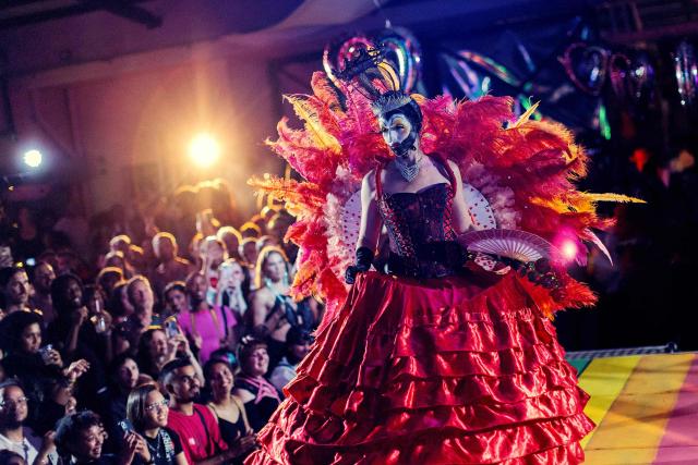 TOPSHOT - A participant walks the runway during competitions at the Love Pride Ball in Cape Town on February 7, 2026. Ballroom culture emerged in New York City in the late 1960s and 1970s, created by Black and Latino transgender and queer communities who were excluded from mainstream drag pageants. In response, they formed alternative kinship structures known as “Houses,” led by “Mothers” and “Fathers,” and organised “Balls,” competitive events where participants perform, walk categories and seek recognition within the community. (Photo by GIANLUIGI GUERCIA / AFP)