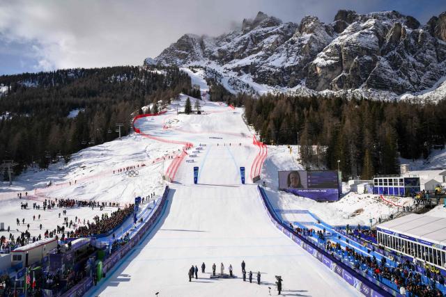 (From L) Silver medallist Germany's Emma Aicher, Gold medallist US' Breezy Johnson and bronze medallist Italy's Sofia Goggiaon pose on podium of the women's downhill event during the Milano Cortina 2026 Winter Olympic Games at the Tofane Alpine Skiing Centre in Cortina d’Ampezzo on February 8, 2026.  (Photo by Marco BERTORELLO / AFP)