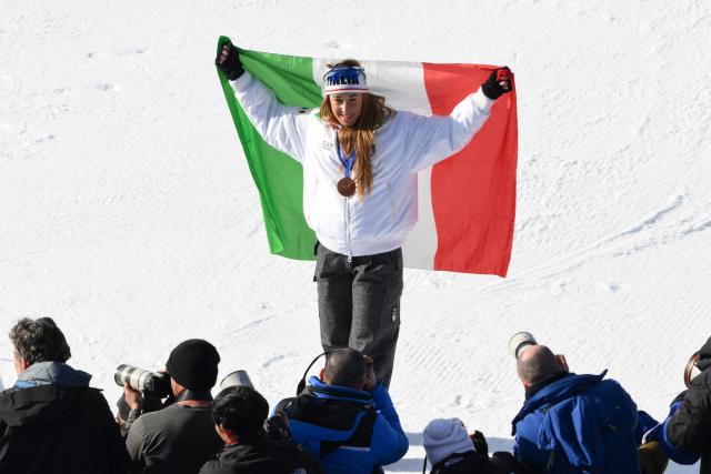 Bronze medallist Italy's Sofia Goggiaon poses during the podium ceremony of the women's downhill event during the Milano Cortina 2026 Winter Olympic Games at the Tofane Alpine Skiing Centre in Cortina d’Ampezzo on February 8, 2026. (Photo by Marco BERTORELLO / AFP)