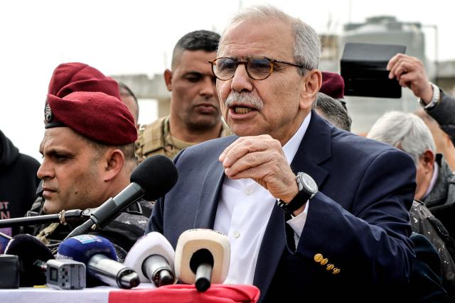 Lebanon's Prime Minister Nawaf Salam speaks to the residents and press corps during his visit to the heavily-damaged southern village of Kfar Shouba, near the border with Israel on February 8, 2026. Swathes of south Lebanon's border areas remain in ruins and largely deserted more than a year after a US-brokered November 2024 ceasefire sought to end hostilities between Israel and the Iran-backed group. Salam vowed authorities would begin key projects including restoring roads, communications networks and water in the two towns (Photo by Rabih DAHER / AFP)
