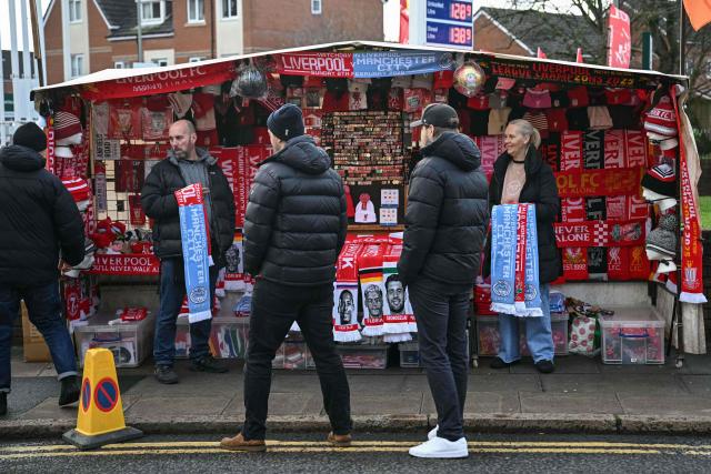 Vendors offer club merchandise at stalls outside the grounds before the start of the English Premier League football match between Liverpool and Manchester City at Anfield in Liverpool, north west England on February 8, 2026. (Photo by Paul ELLIS / AFP)