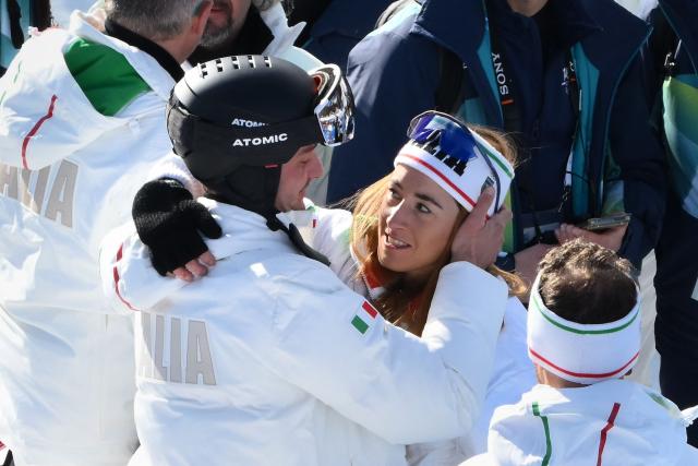 Bronze medallist Italy's Sofia Goggia reacts with member of her team after the podium ceremony of the women's downhill event during the Milano Cortina 2026 Winter Olympic Games at the Tofane Alpine Skiing Centre in Cortina d’Ampezzo on February 8, 2026.  (Photo by Marco BERTORELLO / AFP)