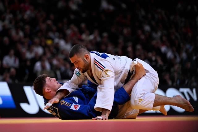 France's Alexis Mathieu (top) competes against Czech Adam Kopecky during their men's -90kg play-off match at the Paris Grand Slam judo tournament in Paris on February 8, 2026. (Photo by Julie SEBADELHA / AFP)